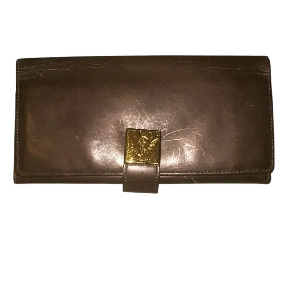 Yves Saint Laurent Tan Leather Wallet with Gold Clasp with marks and scratches.